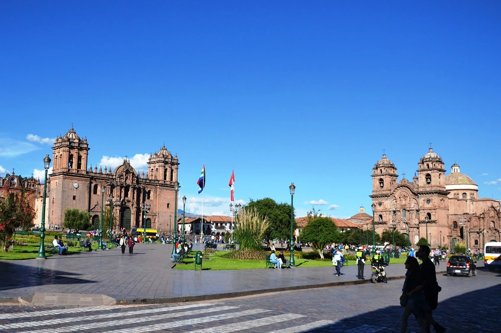 Panoramic view of Plaza de Armas in Cusco, Peru, featuring colonial architecture, vibrant streets, and bustling local activity.
