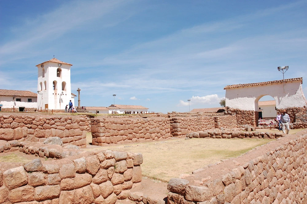 Colorful streets and traditional markets of Chinchero village in the Sacred Valley, Peru, with Andean mountains in the background.